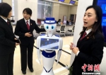 诉讼服务中心工作人员介绍诉讼机器人“小法”。　张金川 摄 - 福建新闻