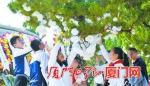 ▲学生们在烈士陵园的松树上系白花，寄托对烈士的缅怀。 - 新浪